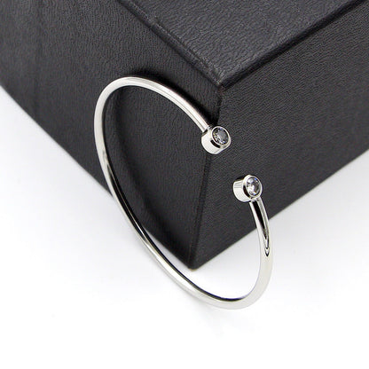 Pulsera abierta dorada con cristales gemelos