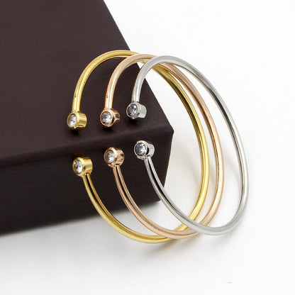 Pulsera abierta dorada con cristales gemelos