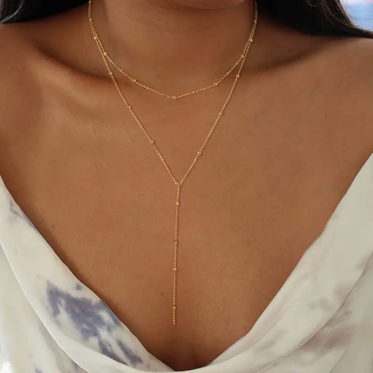 Collar de doble capa con cuentas y borlas geométricas
